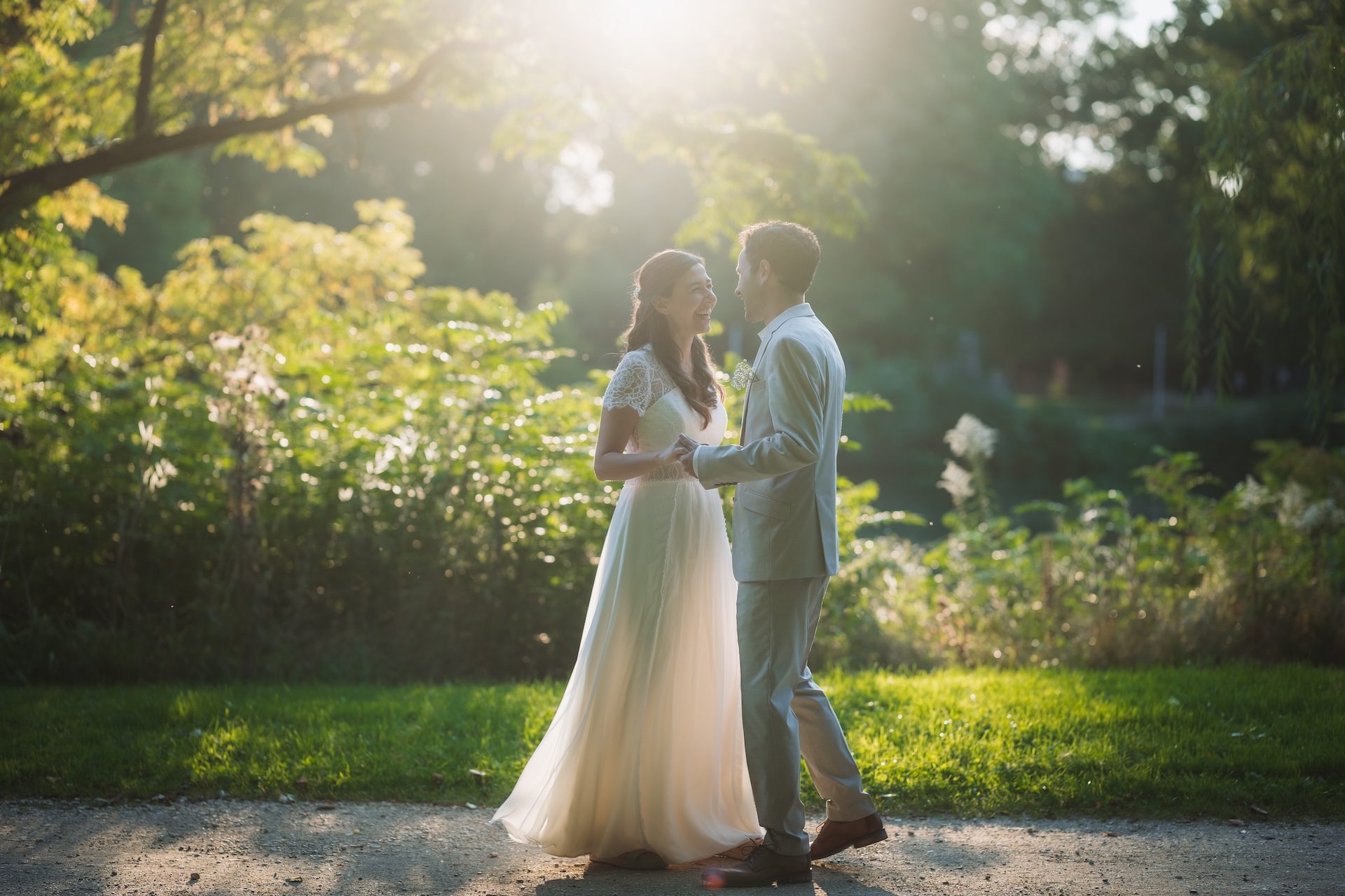 After Wedding Fotografie Ulm, Brautpaar lacht sich an im goldenen Gegenlicht, Parkspaziergang bei Sonnenuntergang